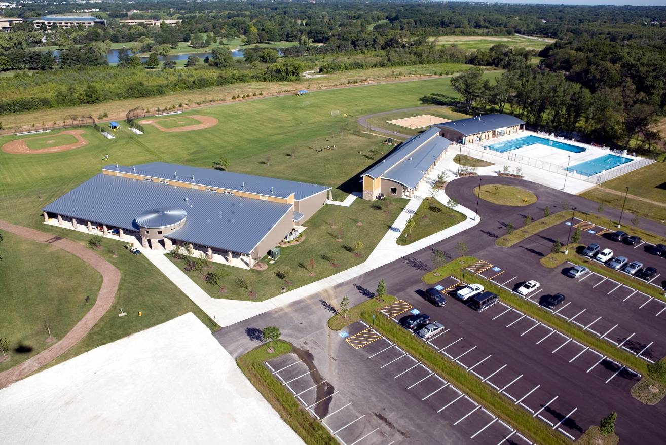 A multi building multi-use indoor/outdoor recreation and activity center. Structural systems were steel frame, long span joists for clear column free space, and brick or stone veneer of light gauge metal stud wall framing.